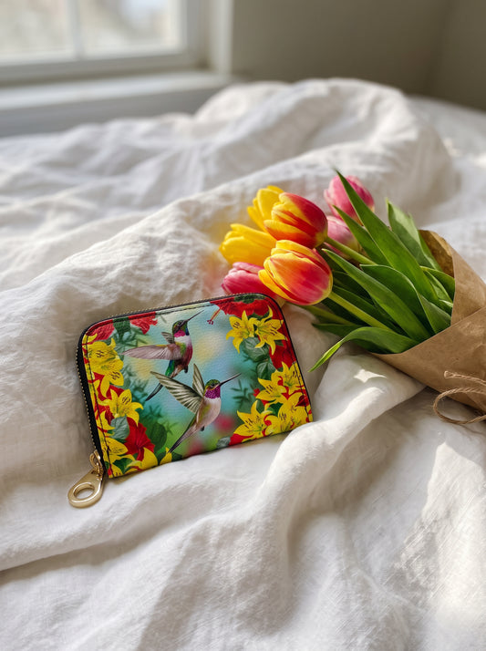 Monarque Red Hummingbird zipper wallet with yellow lilies on white bedding with tulips