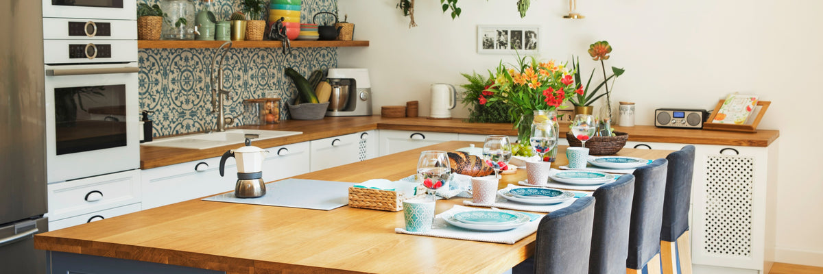 Star Kitchen island with navy chairs and tiled backsplash